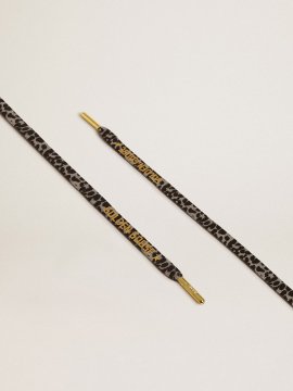 Black and white animal-print laces with contrasting gold-colored logo